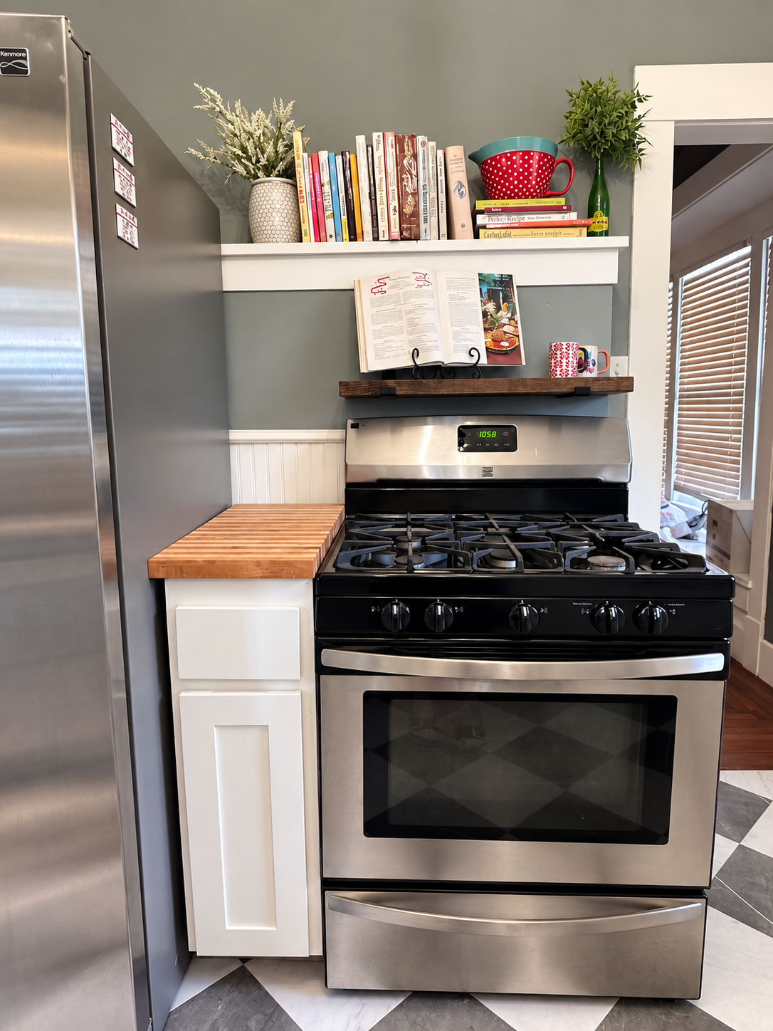 Kitchen range with cookbook, mugs, books, and styled shelf